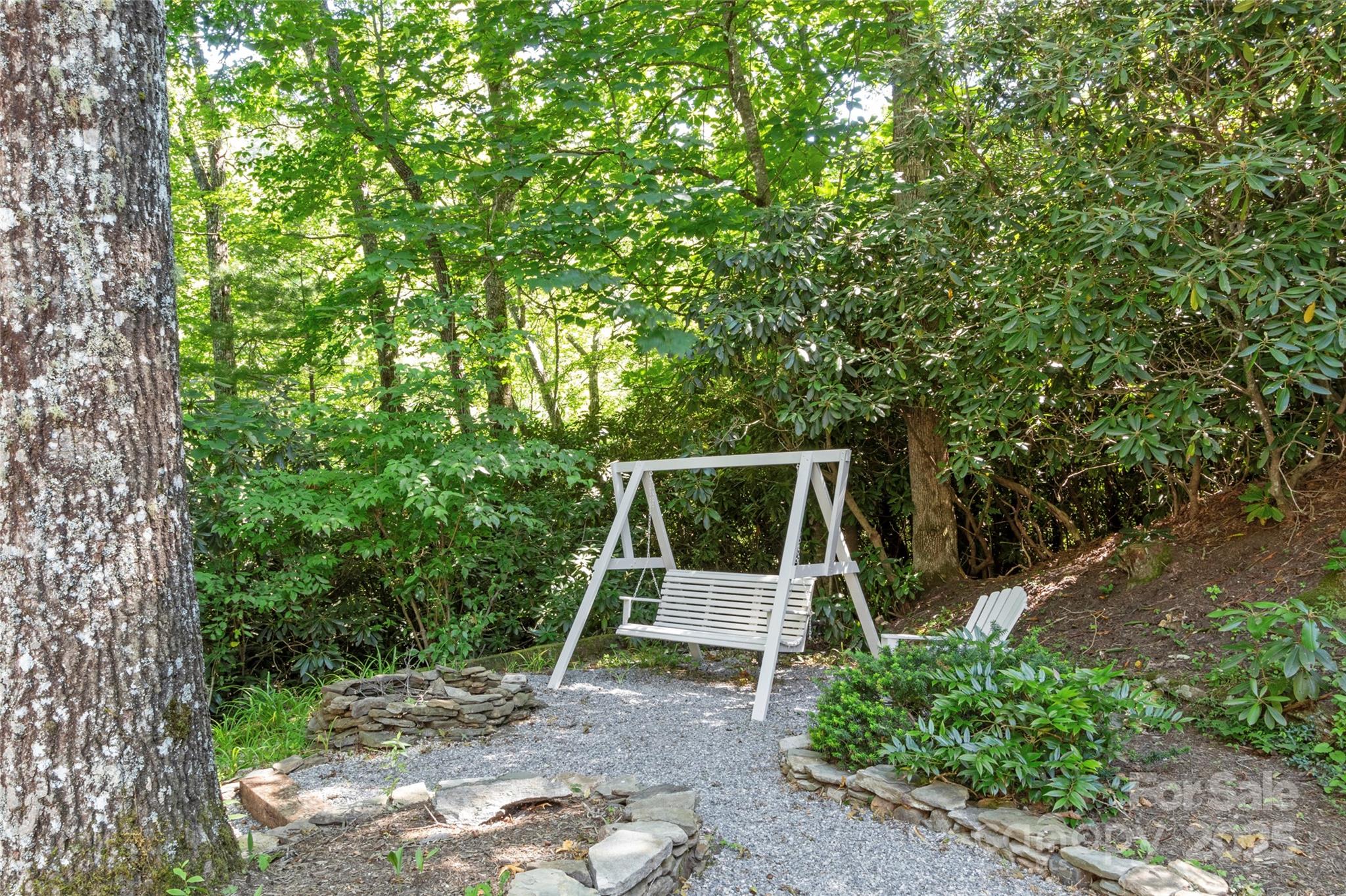 141 Wildflower Road Spruce Pine, NC 28777 - Photo 5 of 22 a backyard of a house with table and chairs