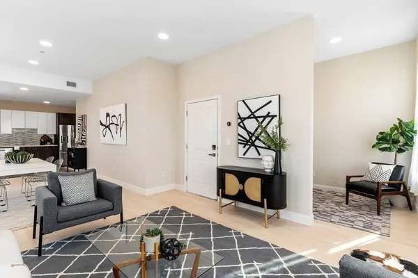 a living room with furniture a rug and a fireplace