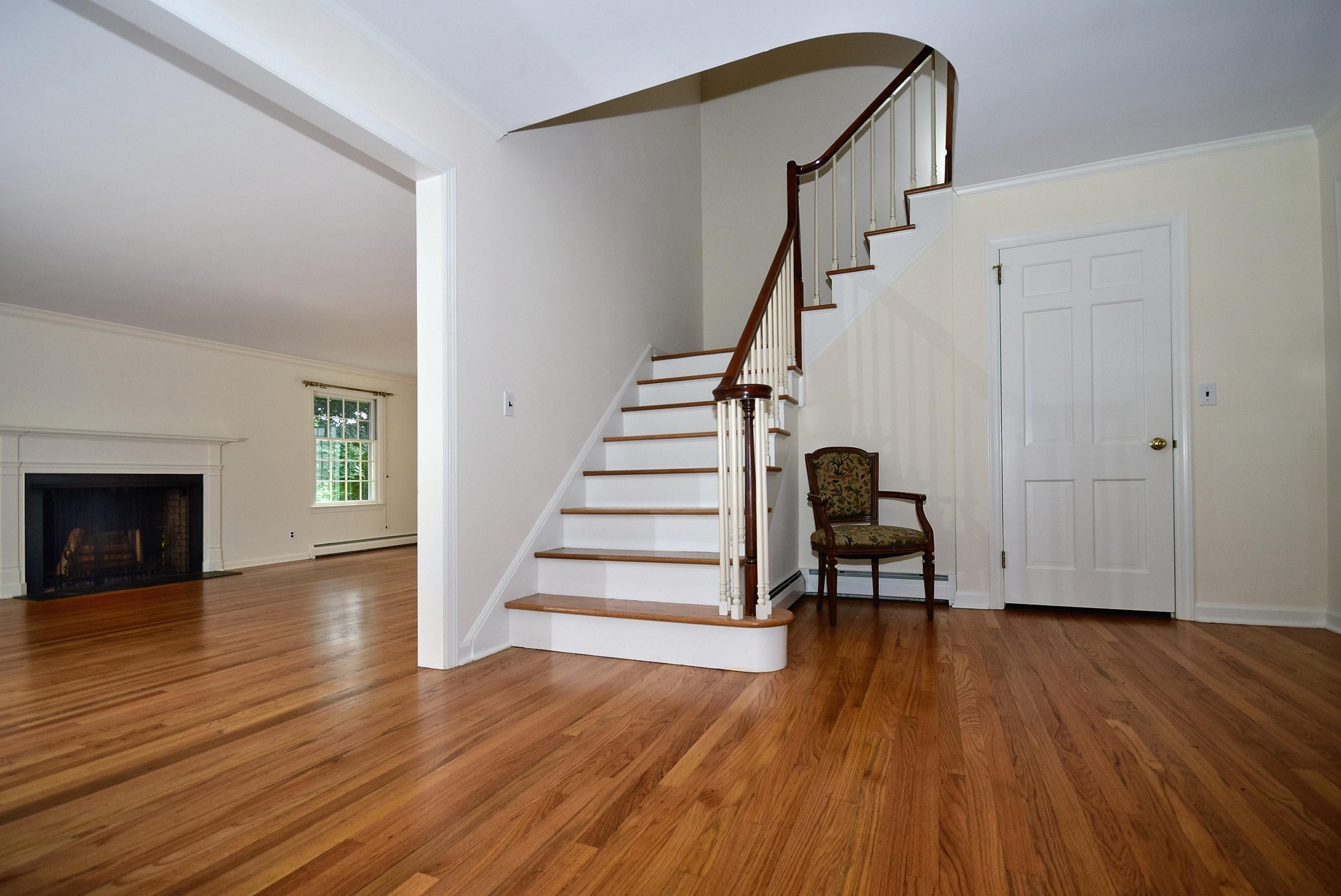 1342 Valley Road New Canaan, CT 06840 - Photo 2 of 10 a view of a livingroom with wooden floor and a staircase