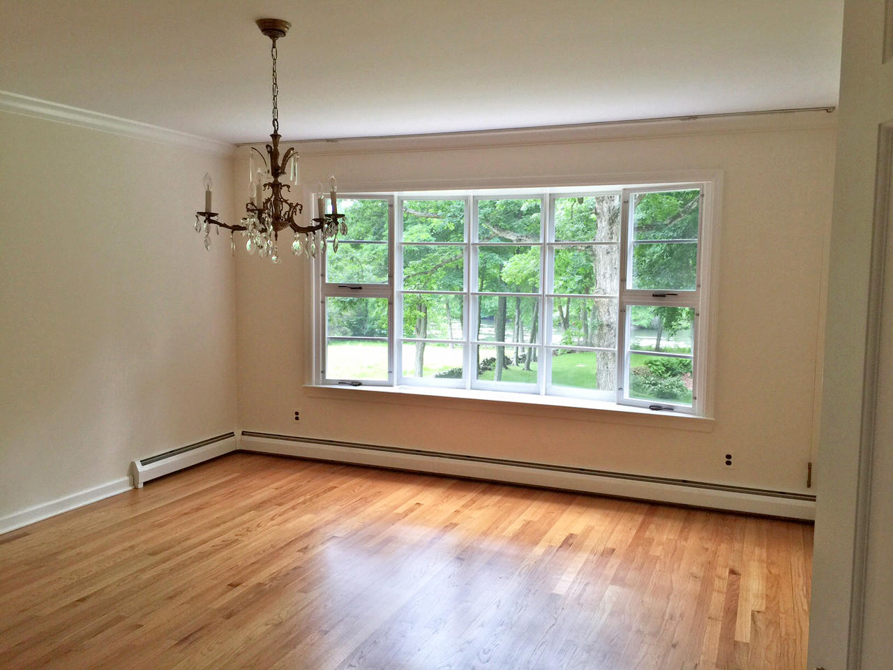 1342 Valley Road New Canaan, CT 06840 - Photo 4 of 10 a view of a room with a window and wooden floor