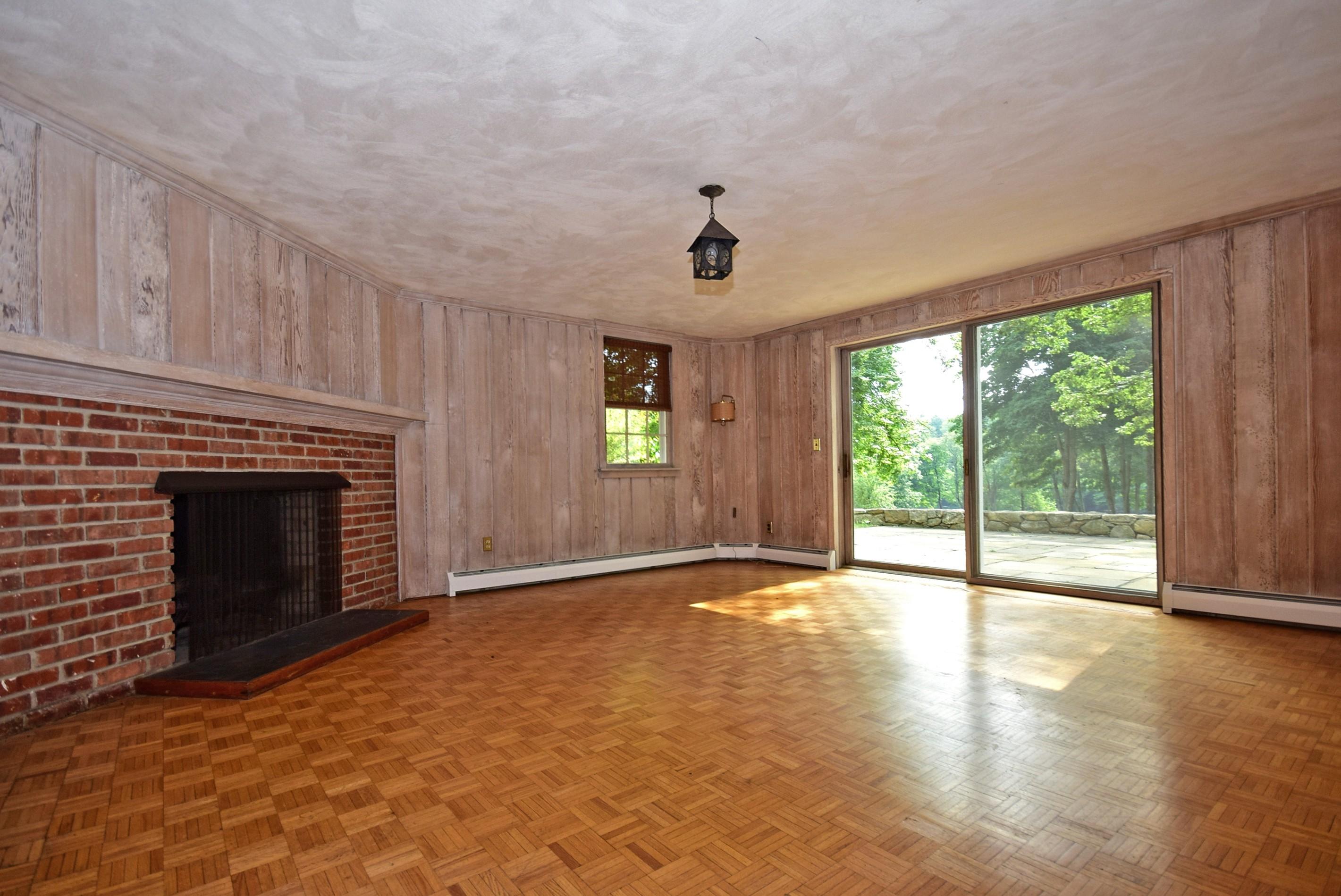 1342 Valley Road New Canaan, CT 06840 - Photo 6 of 10 a view of an empty room with a fireplace and a window