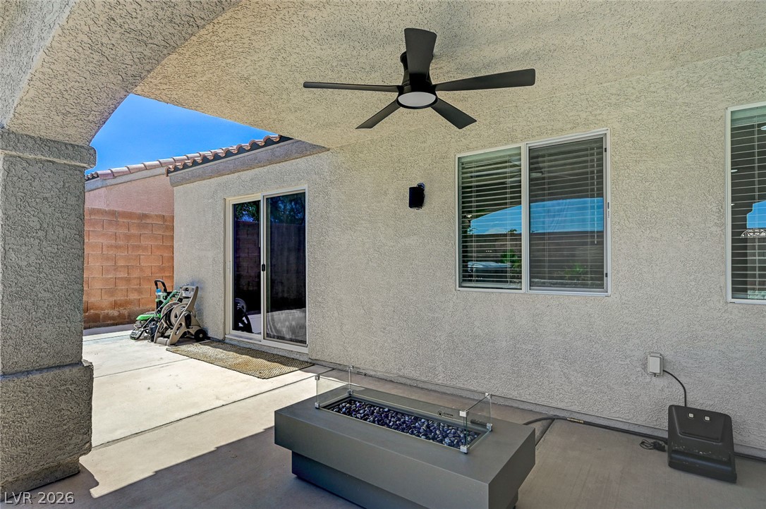 1072 Reed Point Court Henderson, NV 89002 - Photo 54 of 60 An inviting covered patio featuring a modern fire pit, perfect for evening gatherings.