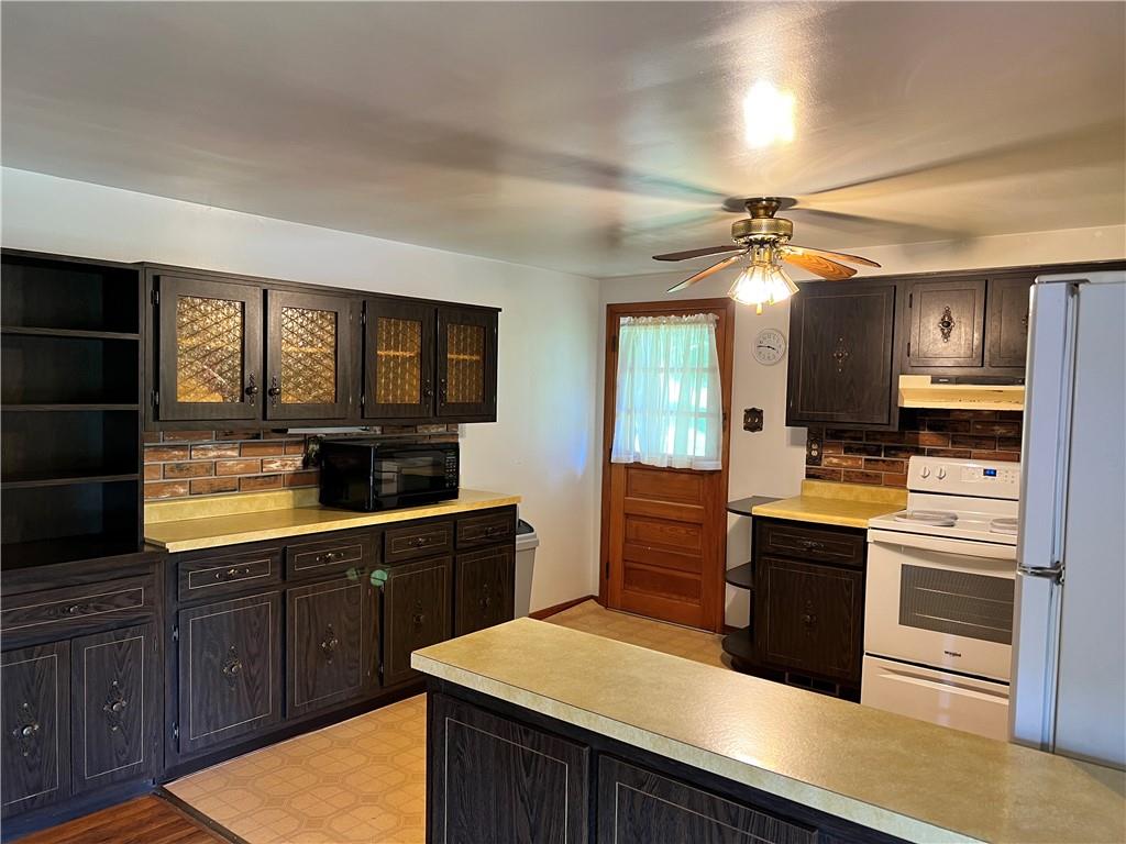 880 Pizza Barn Road Blairsville, PA 15717 - Photo 17 of 44 a kitchen with stainless steel appliances kitchen island granite countertop a refrigerator a stove and a sink with wooden floor