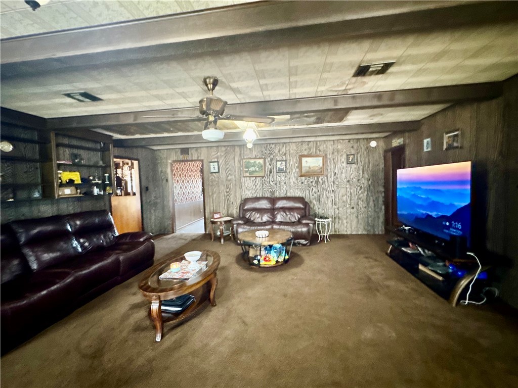 7611 Schramm Road La Grange, TX 78945 - Photo 12 of 30 a living room with furniture gym equipment and a chandelier