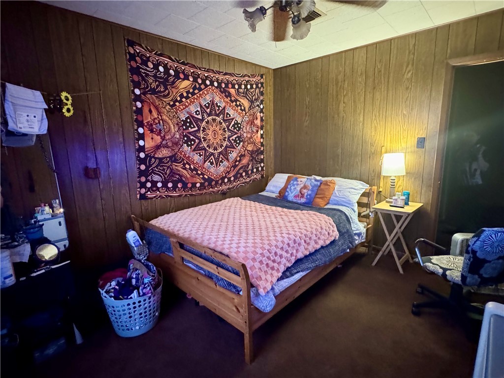 7611 Schramm Road La Grange, TX 78945 - Photo 13 of 30 a bedroom with a bed and a lamp on dresser