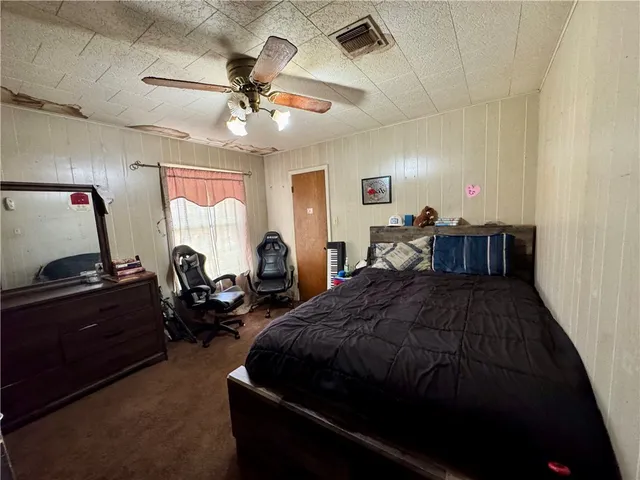 a bed room with a bed and a chandelier