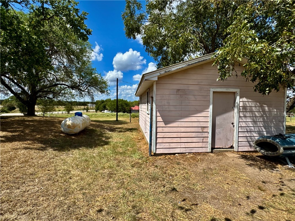 7611 Schramm Road La Grange, TX 78945 - Photo 23 of 30 a backyard of a house with barbeque oven fire pit table and chairs