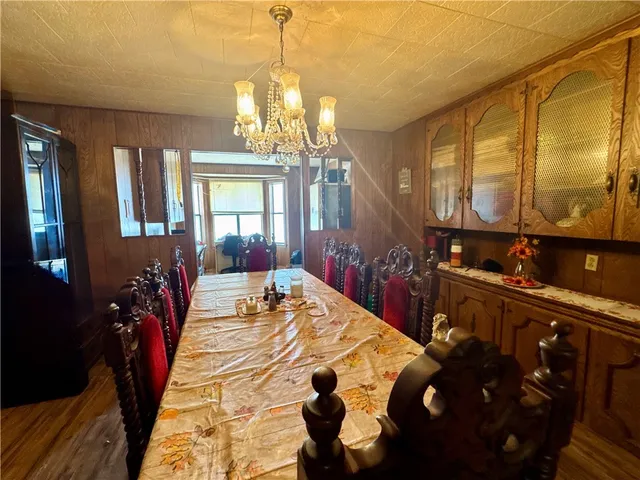 a bed room with a bed mirror and a chandelier