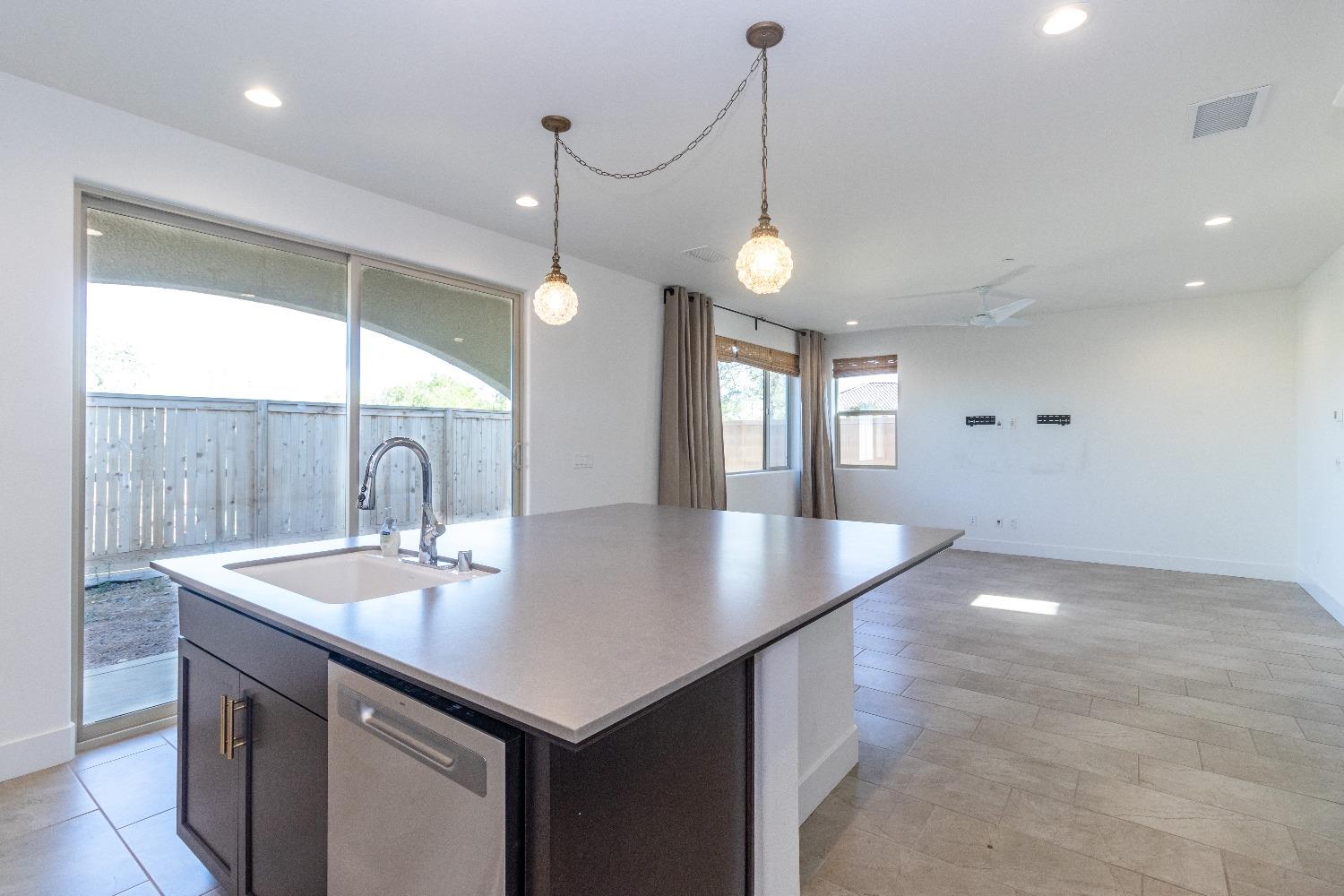4344 Oak Knoll Road Madera, CA 93636 - Photo 11 of 33 a view of kitchen island a sink a window and living room view