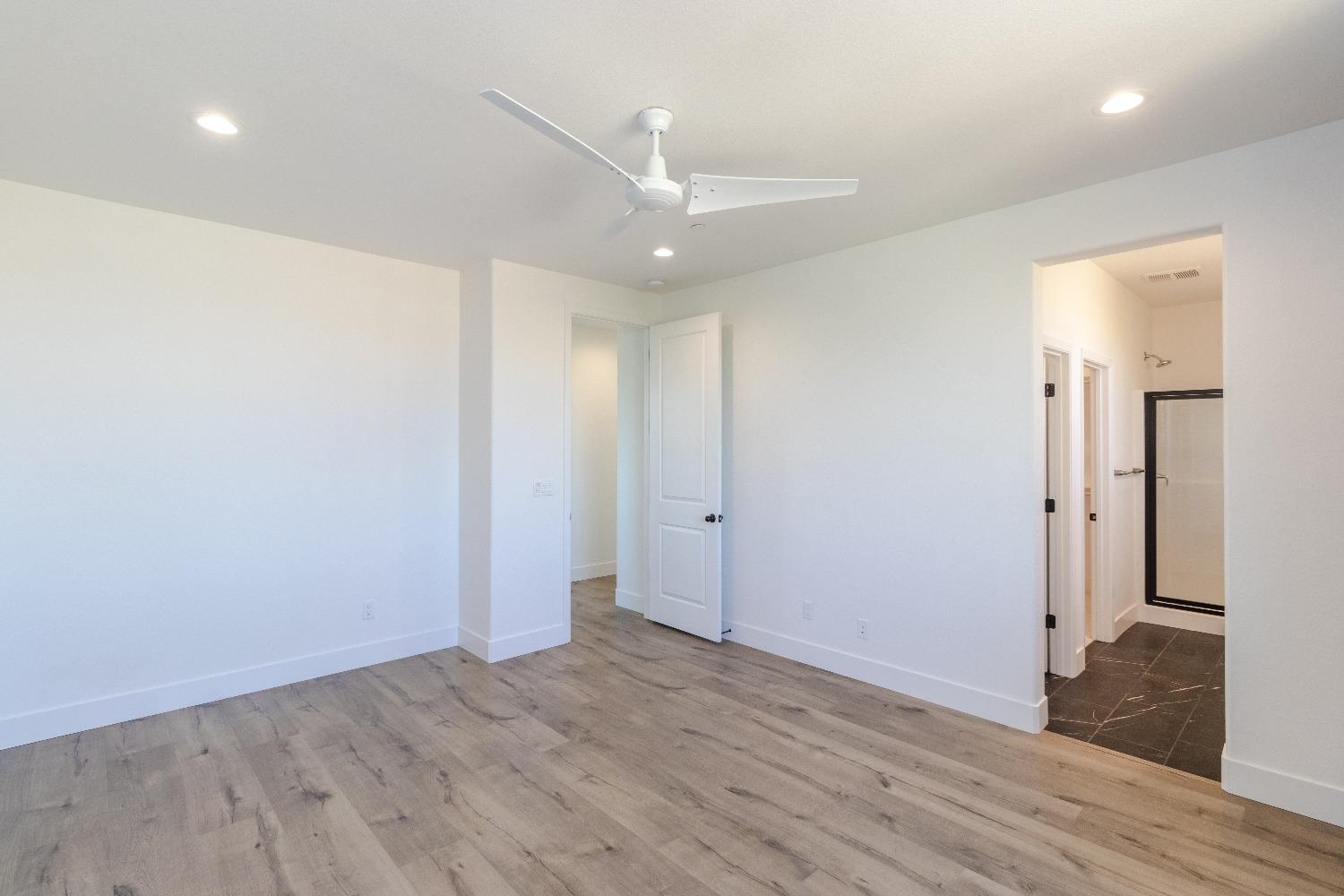 4344 Oak Knoll Road Madera, CA 93636 - Photo 17 of 33 an empty room with wooden floor and entrance