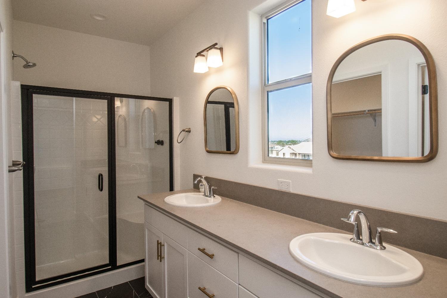 4344 Oak Knoll Road Madera, CA 93636 - Photo 18 of 33 a bathroom with a double vanity sink and a mirror