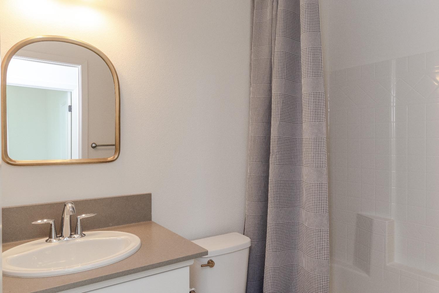 4344 Oak Knoll Road Madera, CA 93636 - Photo 24 of 33 a bathroom with a sink and a mirror