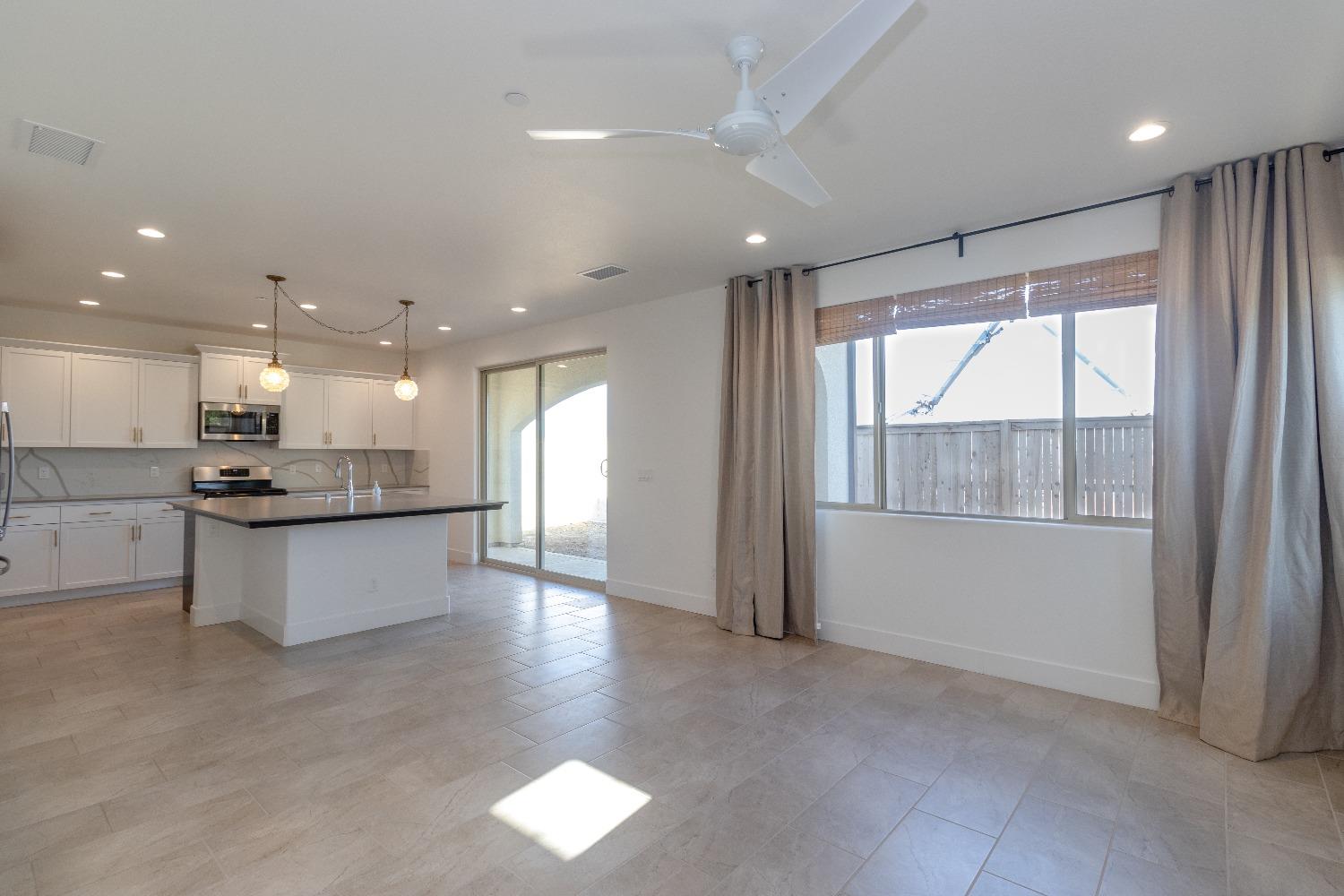 4344 Oak Knoll Road Madera, CA 93636 - Photo 6 of 33 a large kitchen with a large counter top a sink stainless steel appliances and cabinets