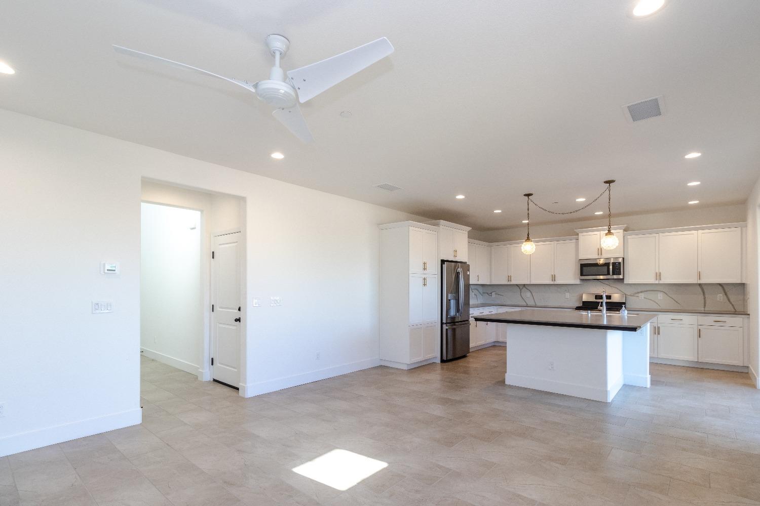 4344 Oak Knoll Road Madera, CA 93636 - Photo 7 of 33 a view of a kitchen with a sink and microwave