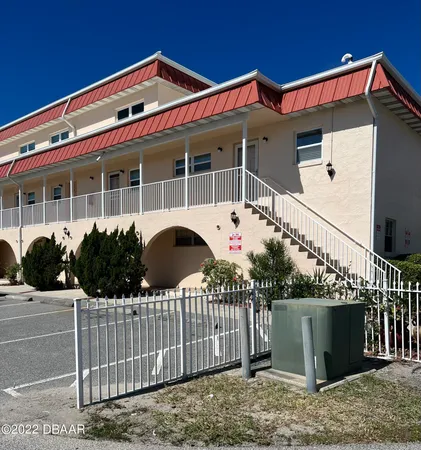 a front view of a house with wooden fence