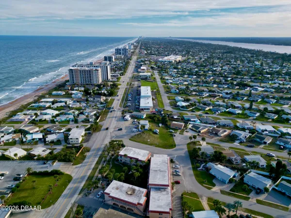 an aerial view of residential houses with outdoor space and swimming pool