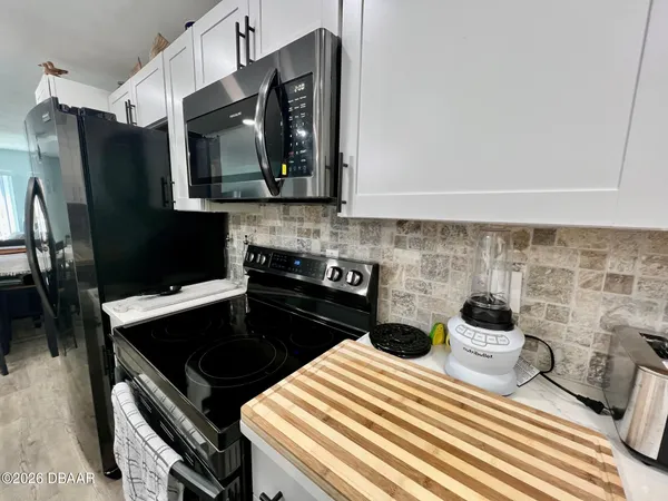 a kitchen with a stove and cabinets