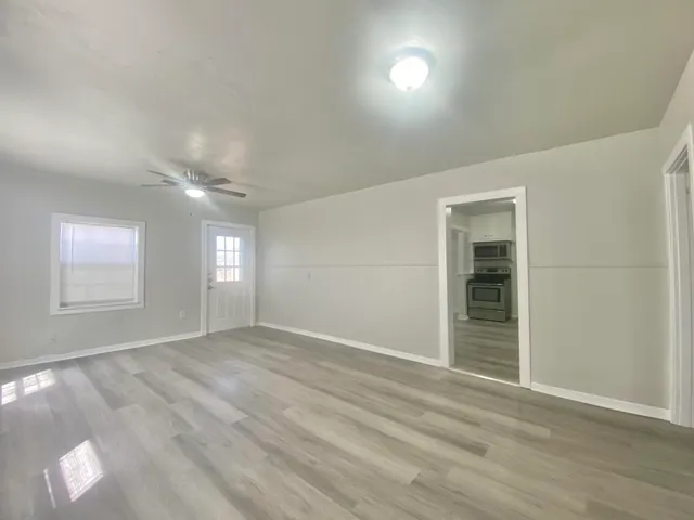 wooden floor in an empty room with a window