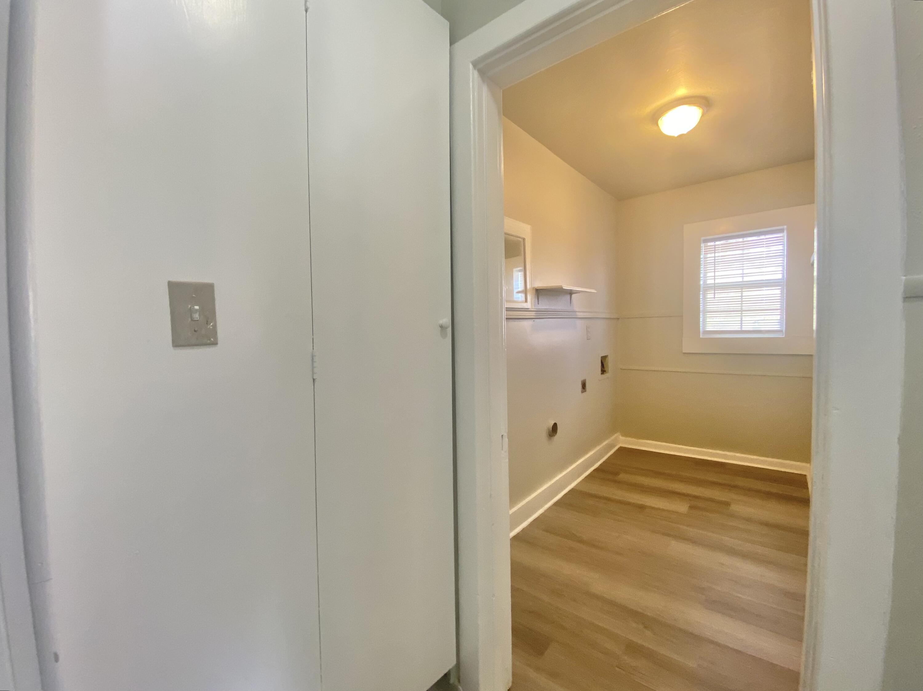 5701 45th Street Lubbock, TX 79414 - Photo 9 of 12 a view of an empty room with wooden floor and a window