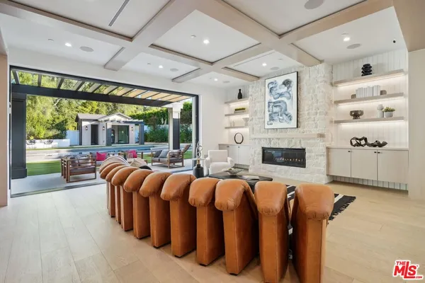 a open kitchen with stainless steel appliances granite countertop a sink a counter top space cabinets and a chandelier