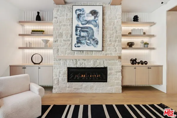 a kitchen with stainless steel appliances granite countertop a sink dishwasher a stove and a refrigerator with wooden floor