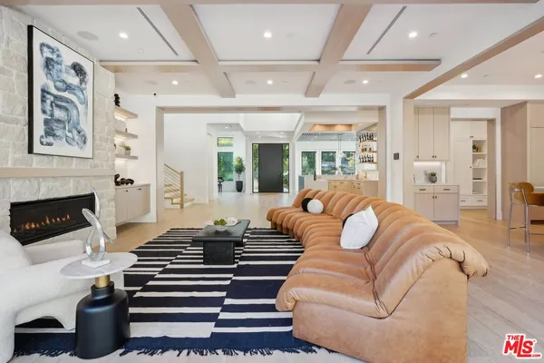 a large white kitchen with stainless steel appliances kitchen island granite countertop a large counter top and sink