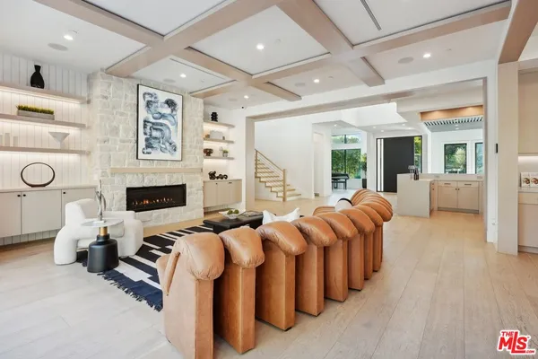 a living room with furniture a fireplace and a large window