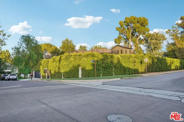 a living room with furniture fireplace and a large window