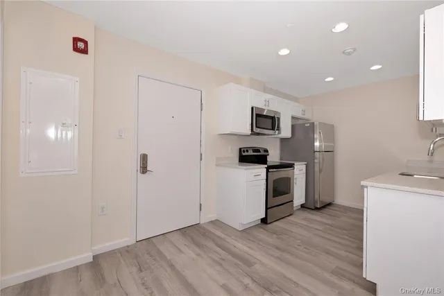 a kitchen with a refrigerator and a stove top oven