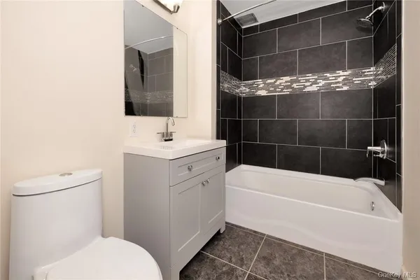 a bathroom with a bathtub toilet and sink