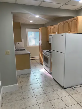 a kitchen with cabinets and refrigerator
