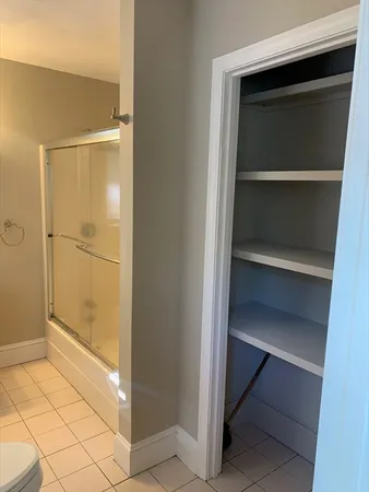 a bathroom with a walk in closet