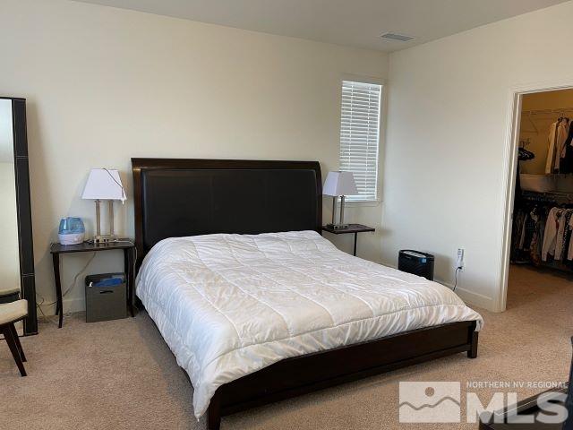2071 Whitecliff Drive Reno, NV 89521 - Photo 23 of 24 a bedroom with a bed and a book shelf