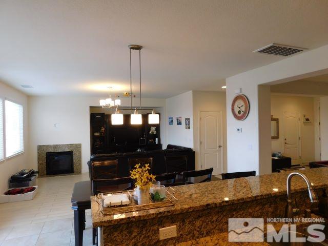2071 Whitecliff Drive Reno, NV 89521 - Photo 24 of 24 a living room with furniture a flat screen tv and kitchen view