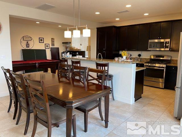 2071 Whitecliff Drive Reno, NV 89521 - Photo 5 of 24 a kitchen with a dining table chairs and refrigerator