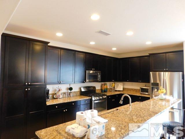2071 Whitecliff Drive Reno, NV 89521 - Photo 8 of 24 a kitchen with a refrigerator and a stove top oven