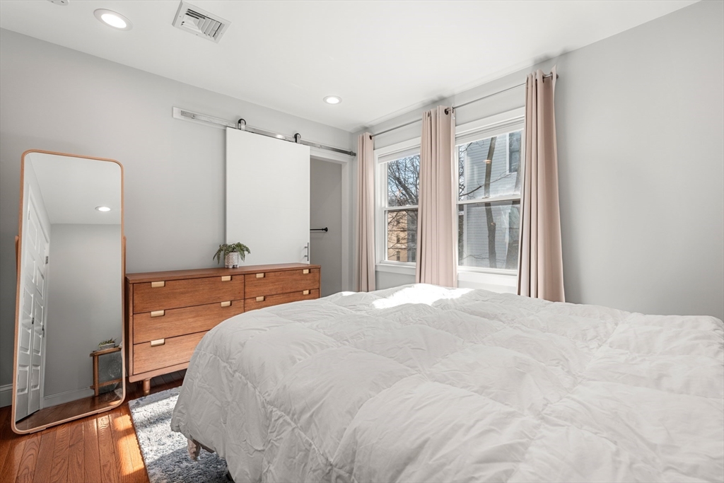 78-80 Rossmore Road, Unit 2 Boston, MA 02130 - Photo 9 of 19 a bedroom with a large bed and a dresser