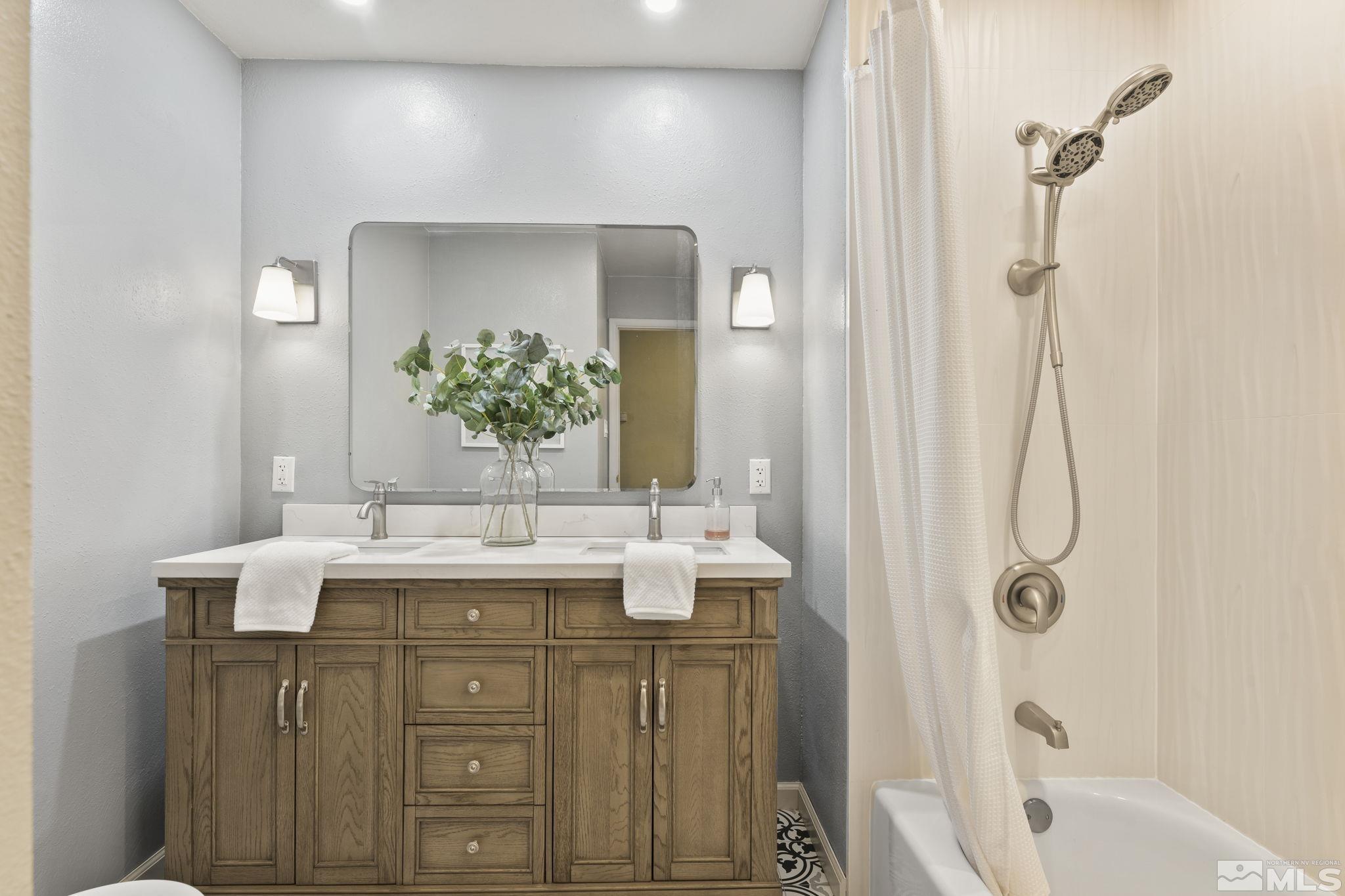 2250 Barnes Boulevard Reno, NV 89509 - Photo 15 of 40 a bathroom with a granite countertop sink and a mirror