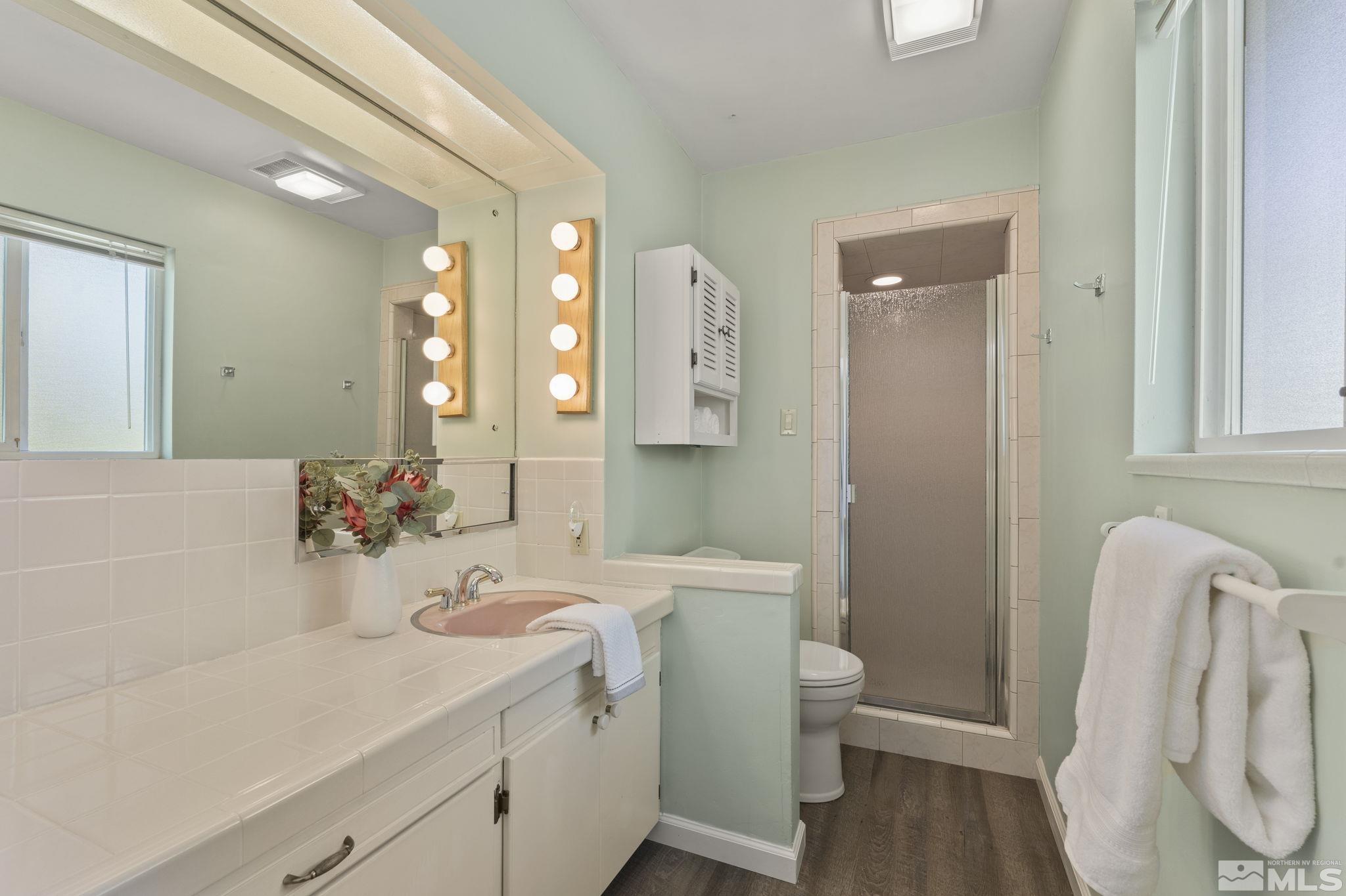 2250 Barnes Boulevard Reno, NV 89509 - Photo 17 of 40 a bathroom with a sink vanity granite and toilet