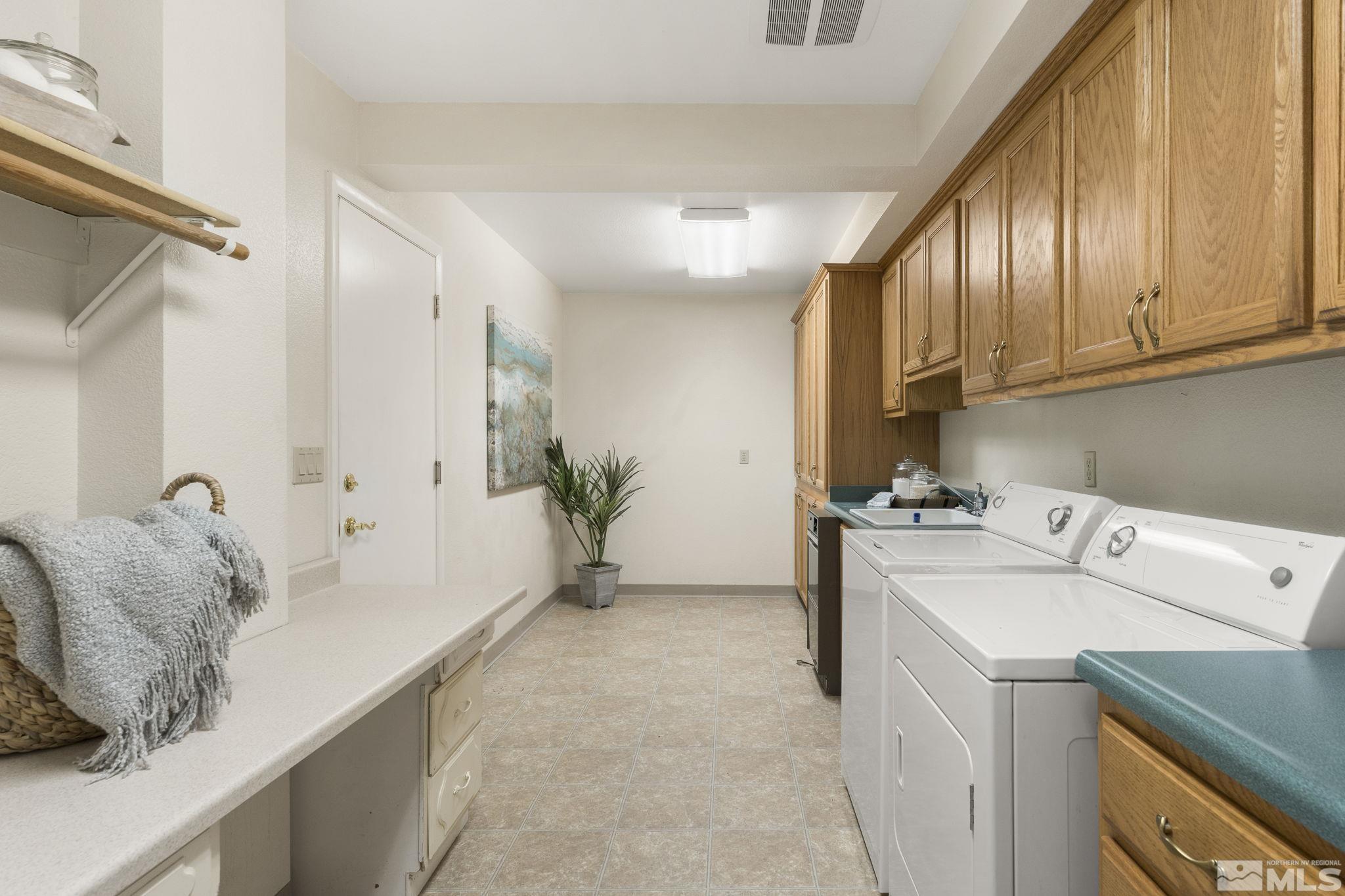 2250 Barnes Boulevard Reno, NV 89509 - Photo 18 of 40 a kitchen with a stove a sink and a refrigerator