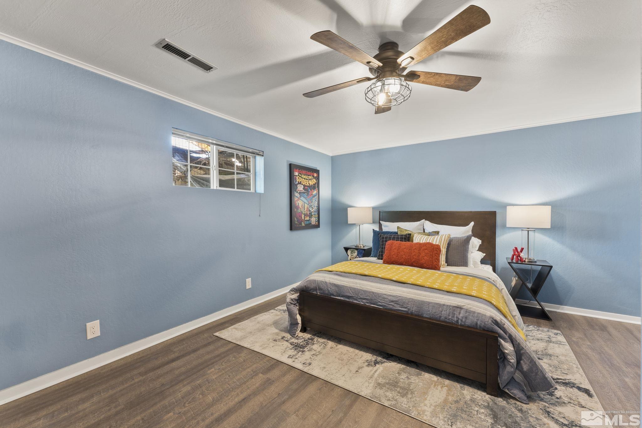 2250 Barnes Boulevard Reno, NV 89509 - Photo 23 of 40 a bedroom with a bed and a chandelier