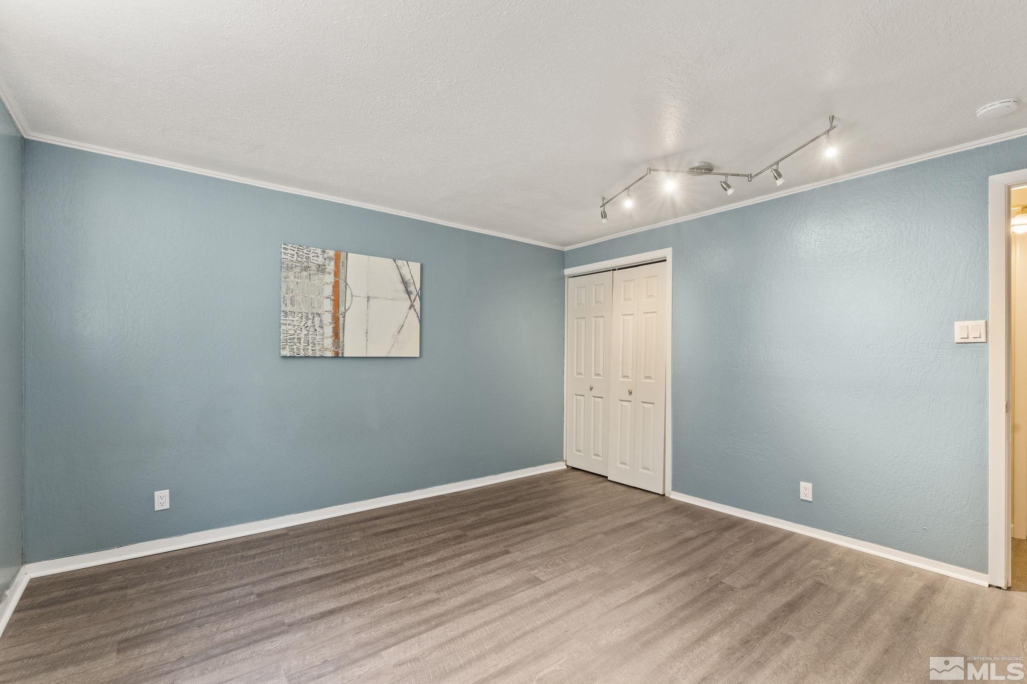 2250 Barnes Boulevard Reno, NV 89509 - Photo 25 of 40 a view of an empty room with wooden floor and a ceiling fan