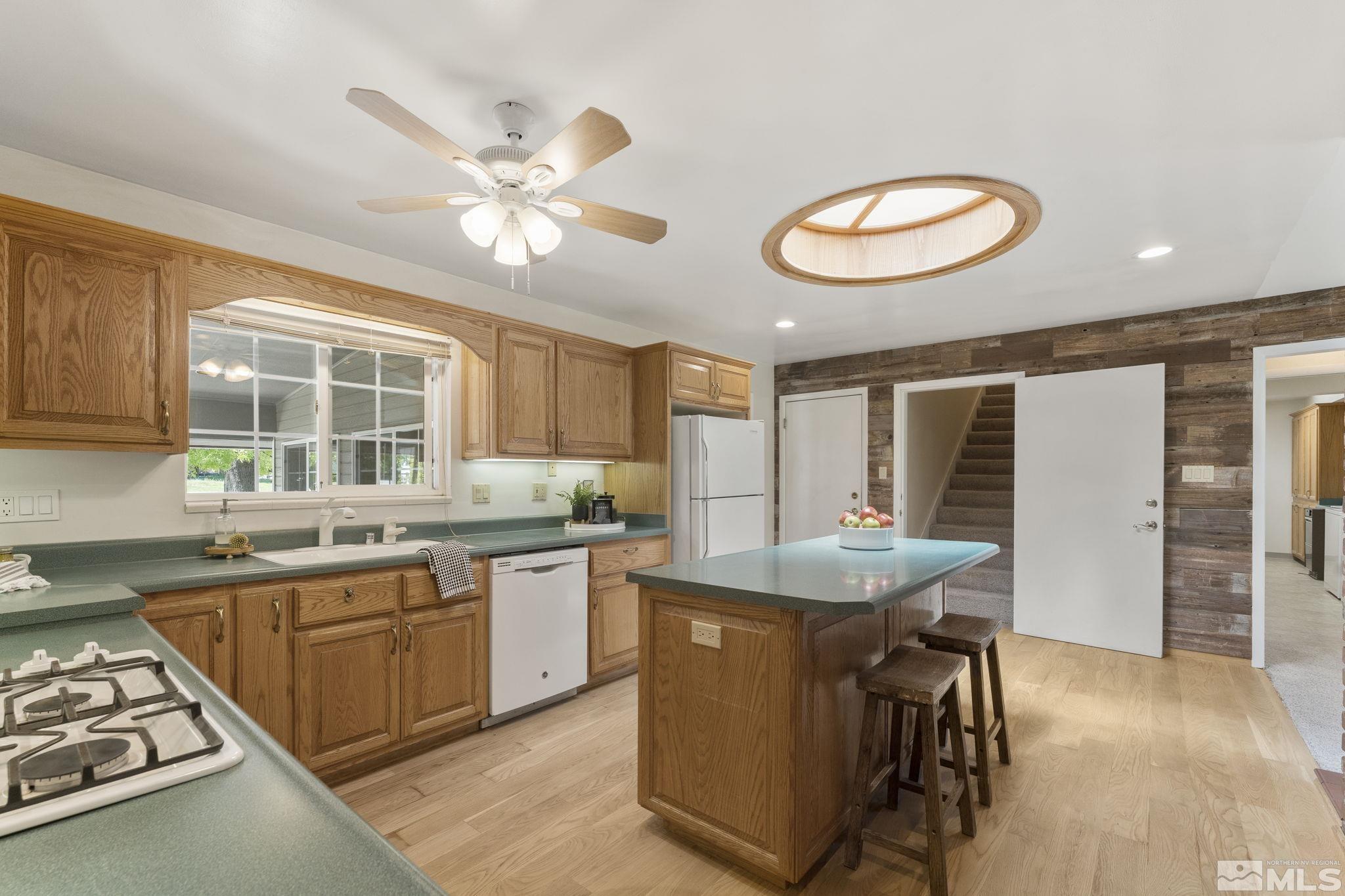 2250 Barnes Boulevard Reno, NV 89509 - Photo 7 of 40 a kitchen with stainless steel appliances granite countertop a stove and a sink