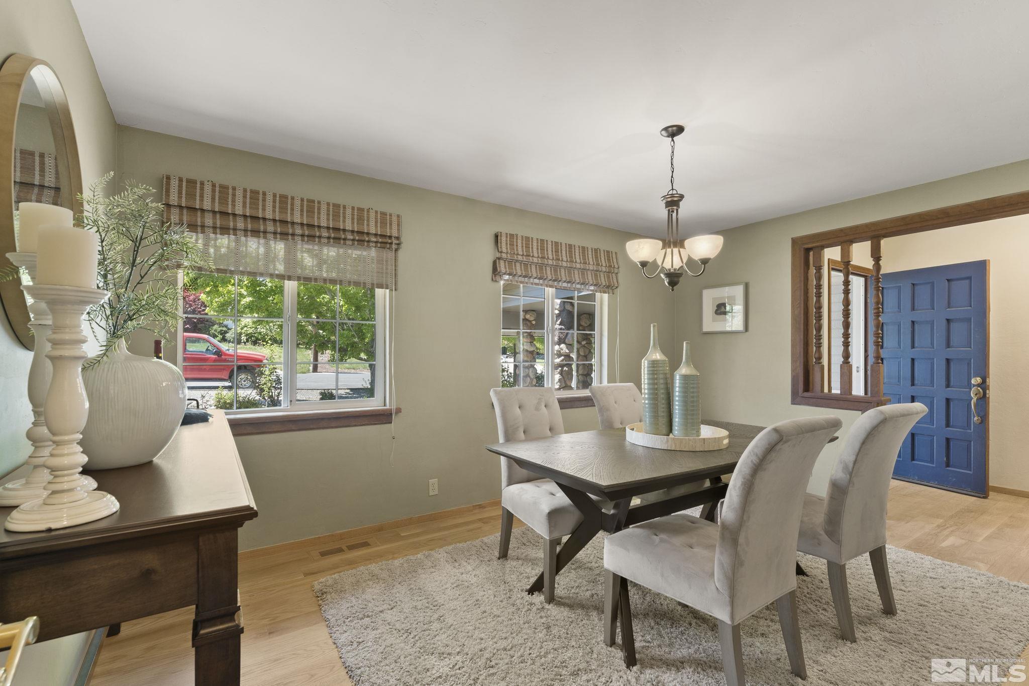 2250 Barnes Boulevard Reno, NV 89509 - Photo 8 of 40 a dining room with furniture a chandelier and wooden floor