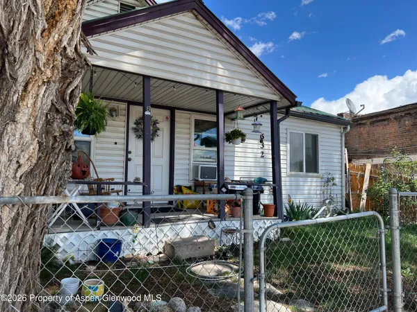 a front view of house with car parked