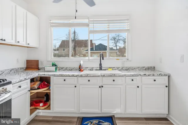 a kitchen with stainless steel appliances a stove a sink and cabinets
