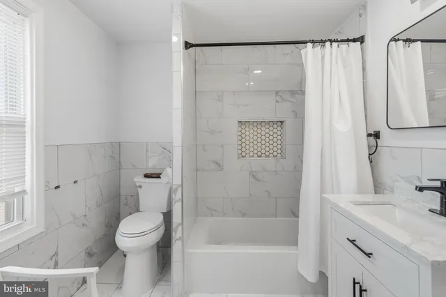 a bathroom with a sink a toilet a mirror and vanity