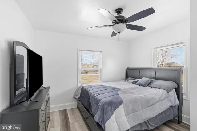 a bathroom with a granite countertop sink a toilet and shower