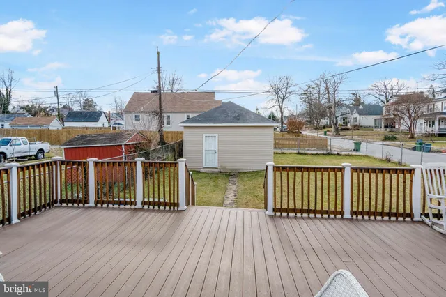 a view of a house with wooden deck and sitting area