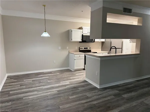 a kitchen with stainless steel appliances granite countertop a sink stove and microwave